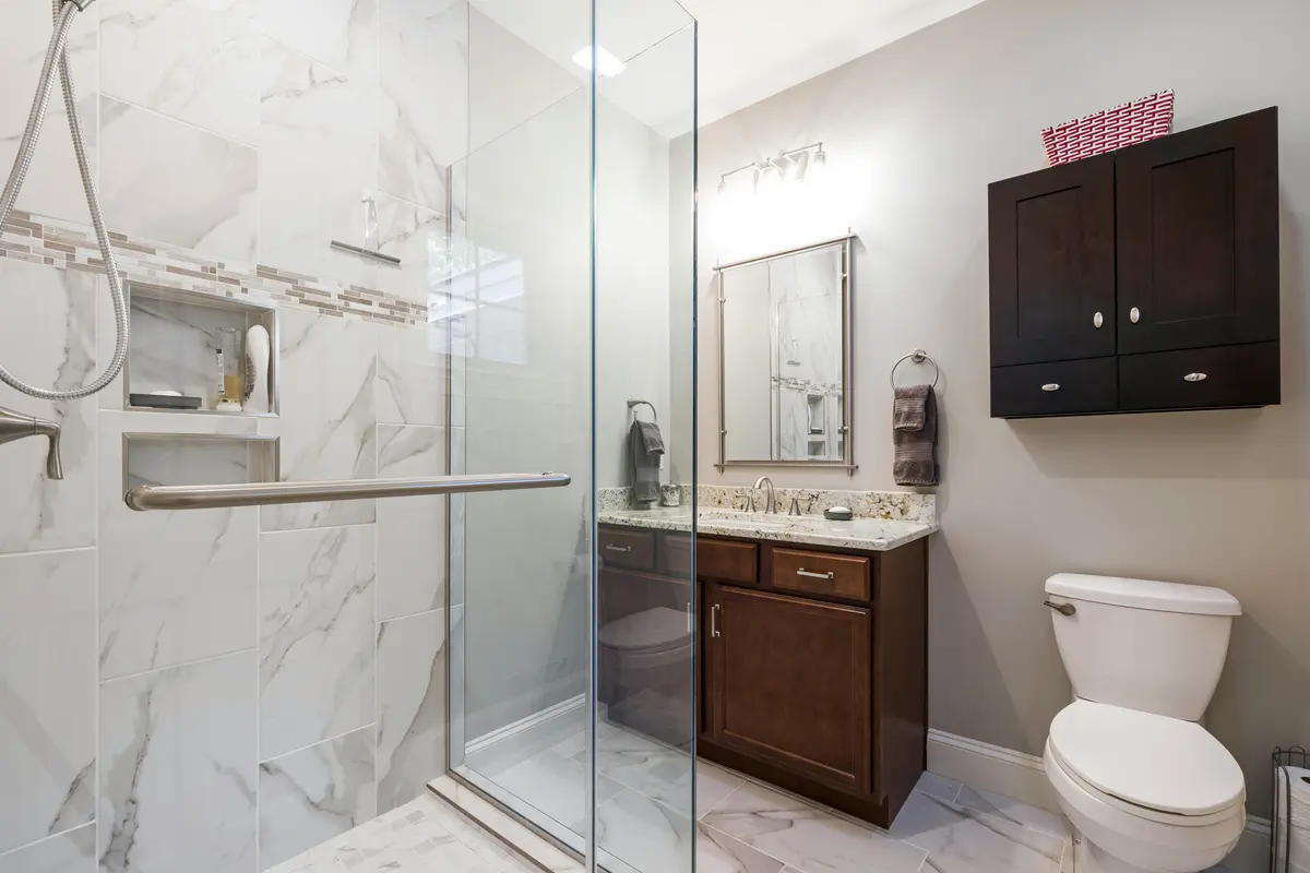 Modern marble bathroom with glass walk-in shower and vanity